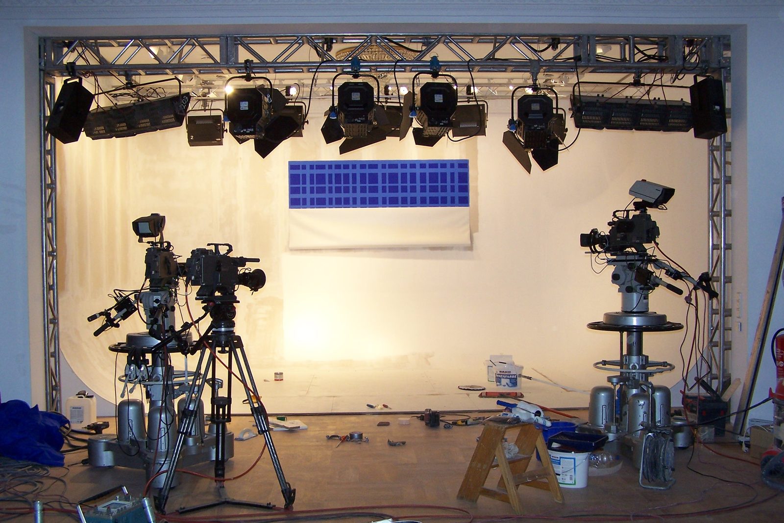 The stage at Theater im Zimmer during the build, cyclorama going in beneath the lighting truss