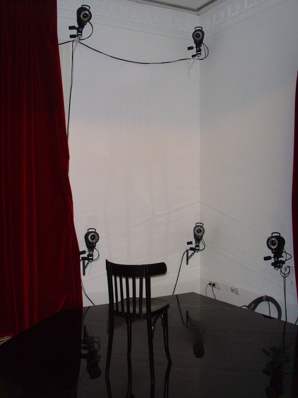 Six Vicon infrared cameras mounted around a single chair for close-range facial capture